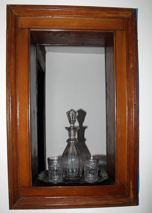 Window from the bar to the ladies parlor
